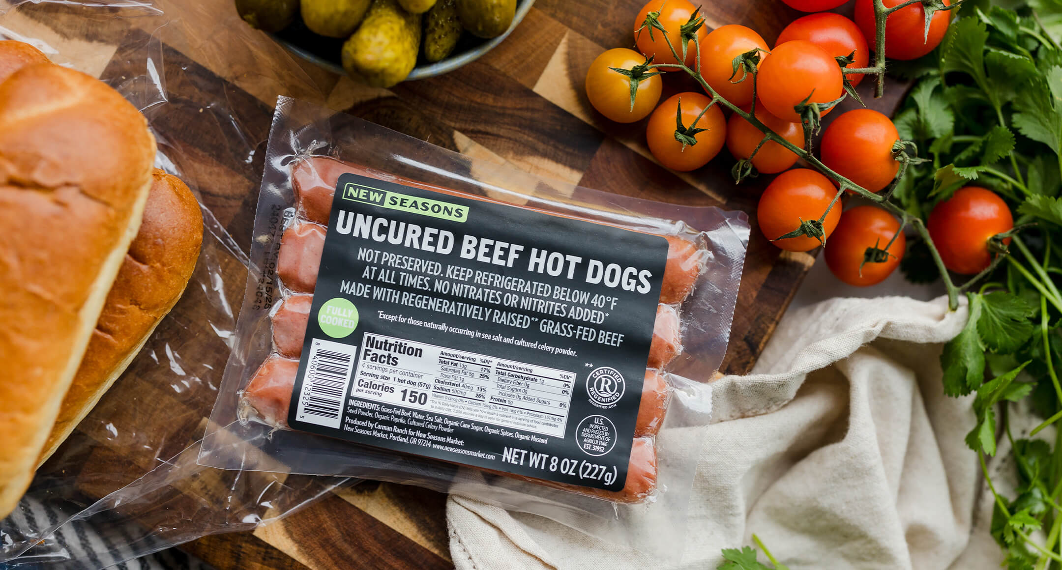 A package of New Seasons Uncured Beef Hot Dogs on a countertop.