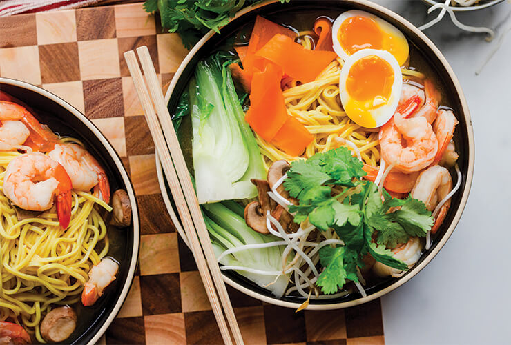 Two bowls of weeknight ramen soup with fresh veggies and jammy eggs.