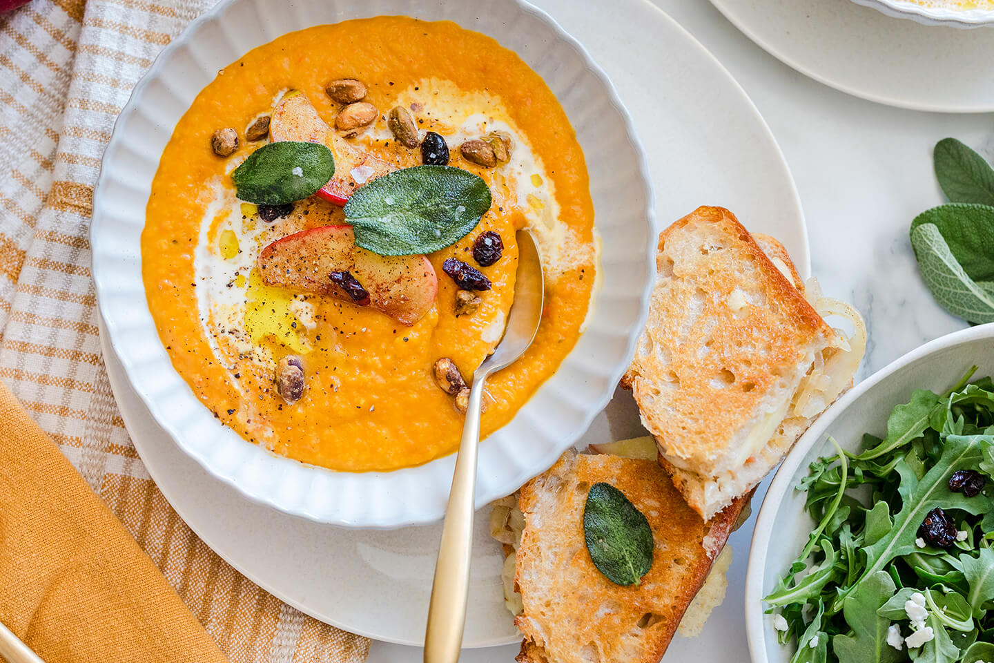 Roasted butternut squash and carrot soup and grilled cheese with caramelized onions, apples, and fried sage.