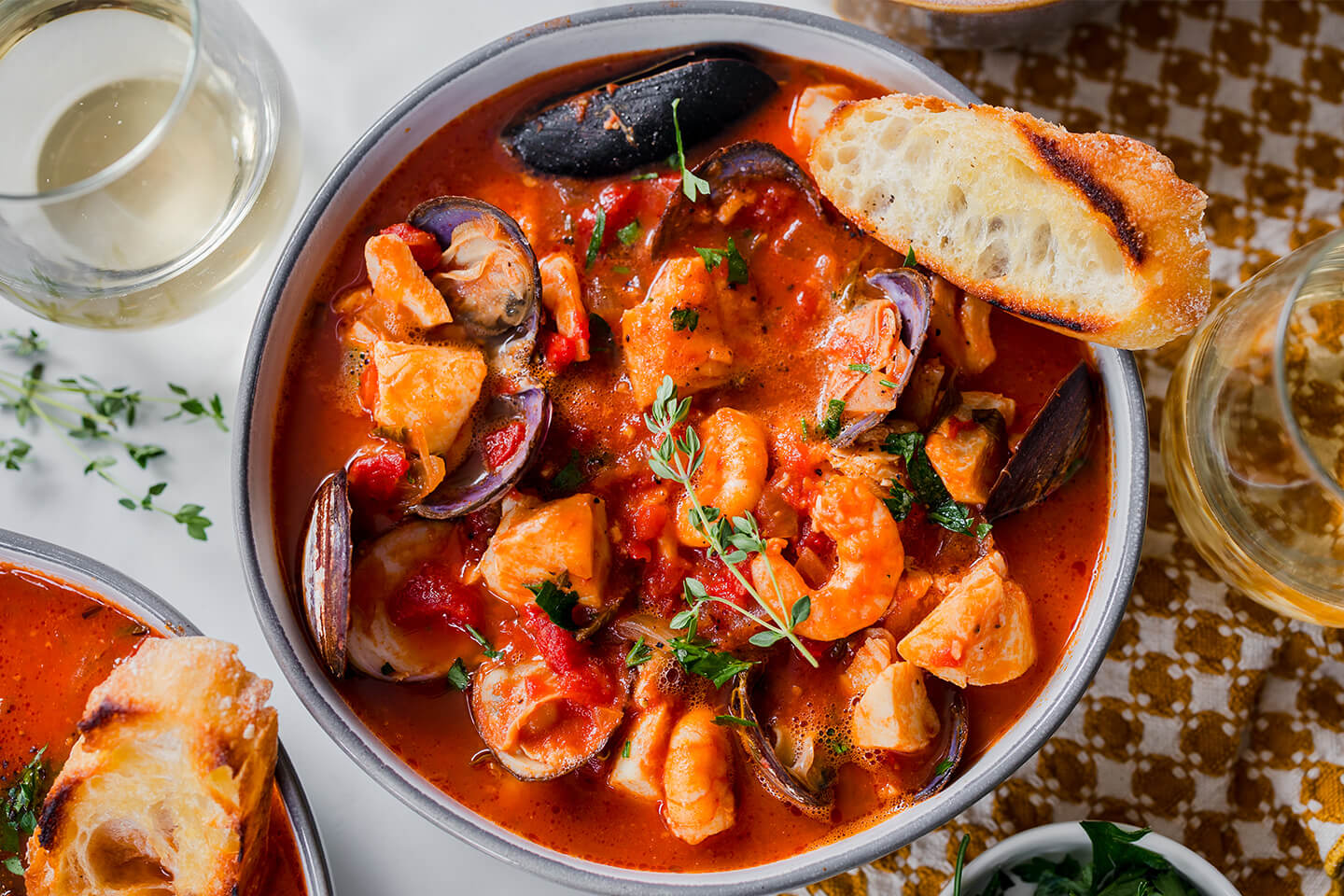 A hearty, one-pot seafood stew served with toasted baguette.
