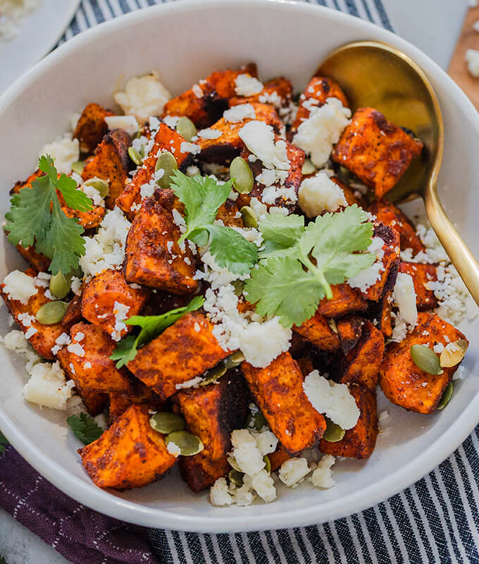 A fall recipe in a bowl with Roasted Sweet Potatoes with Cotija cheese