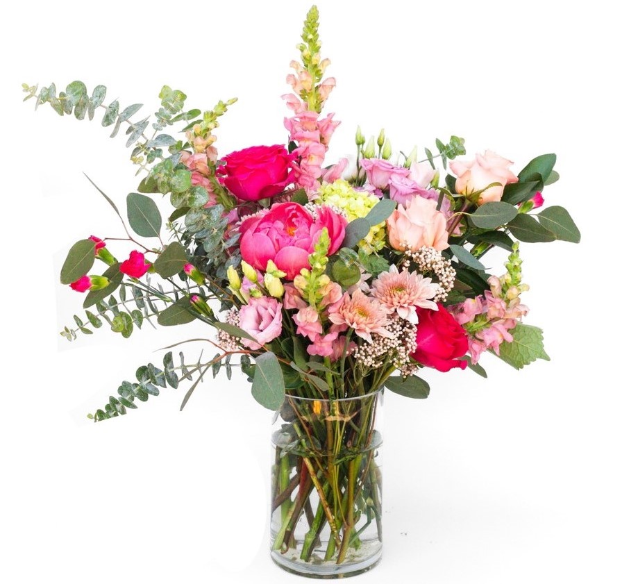 Magenta and green florals and greenery in a vase.