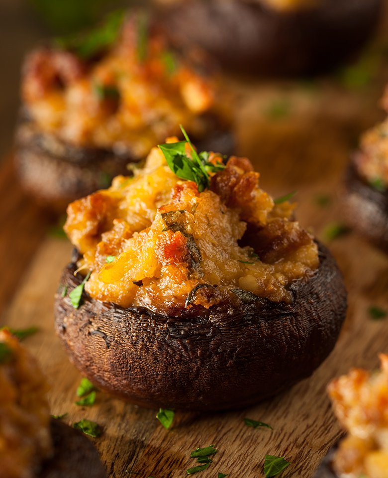 A ground sausage and olive tapenade stuffed cremini mushroom.