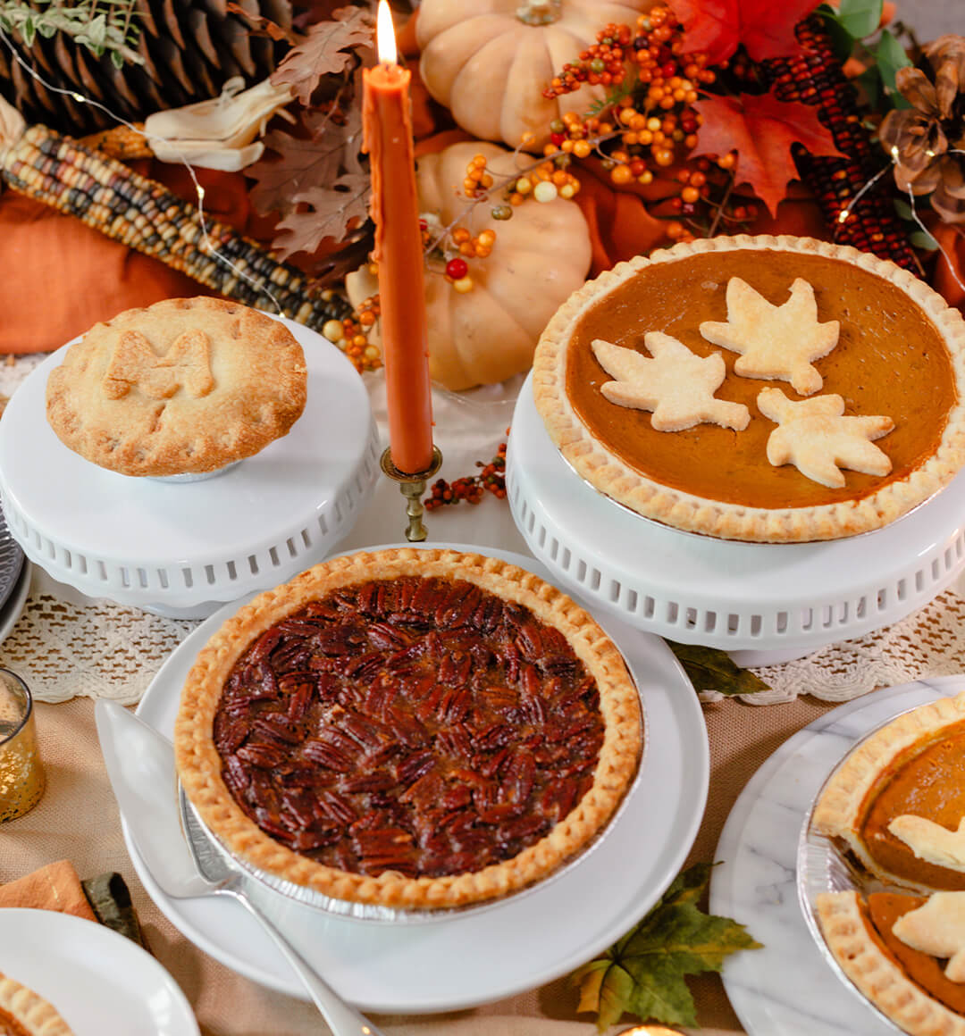 A table set with a pecan pie, pumpkin pie and marrionberry pie