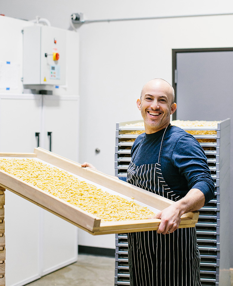 Adam Berger of Rallenti Pasta with a pan of macaroni