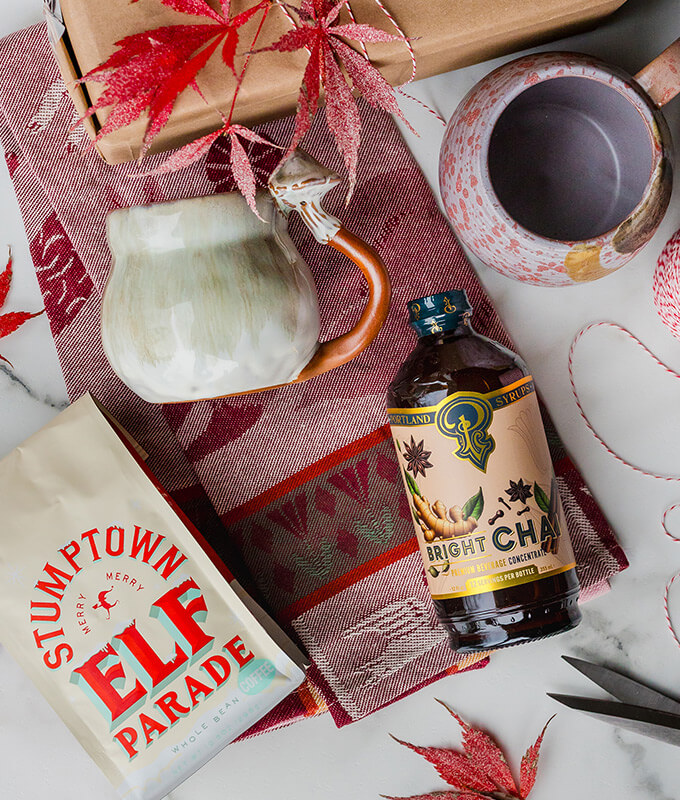 a selection of fun gifting items like nice mugs, coffee, and peppermint syrup