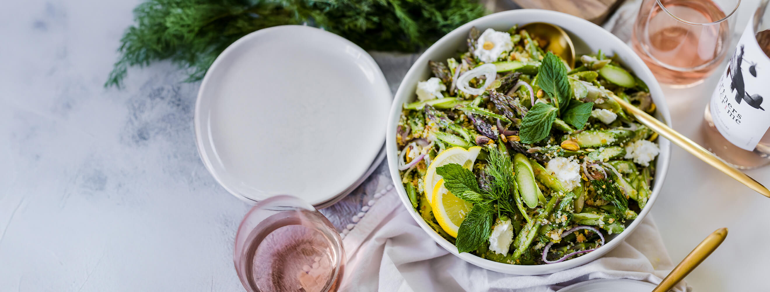 Salad with raw asparagus served in a bowl with a soft boiled egg.