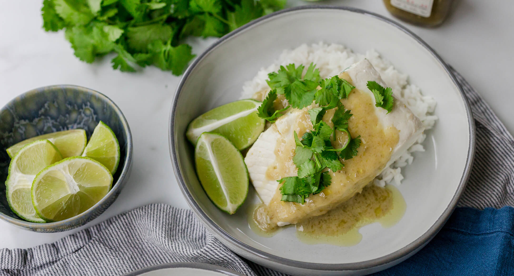 Poached white fish served with rice in a bowl.