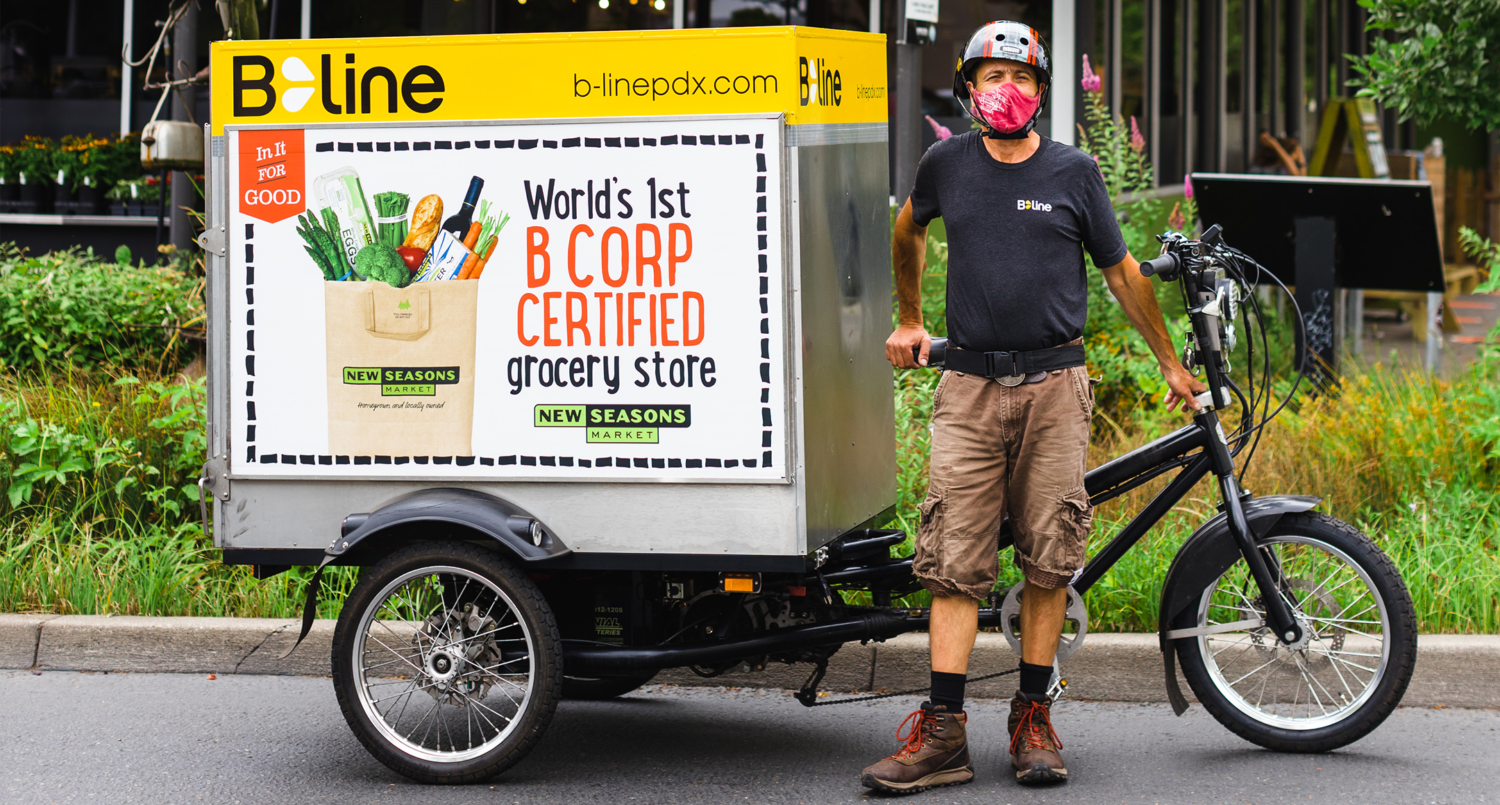 A B-Line Urban Delivery worker poses with their trike and truck.