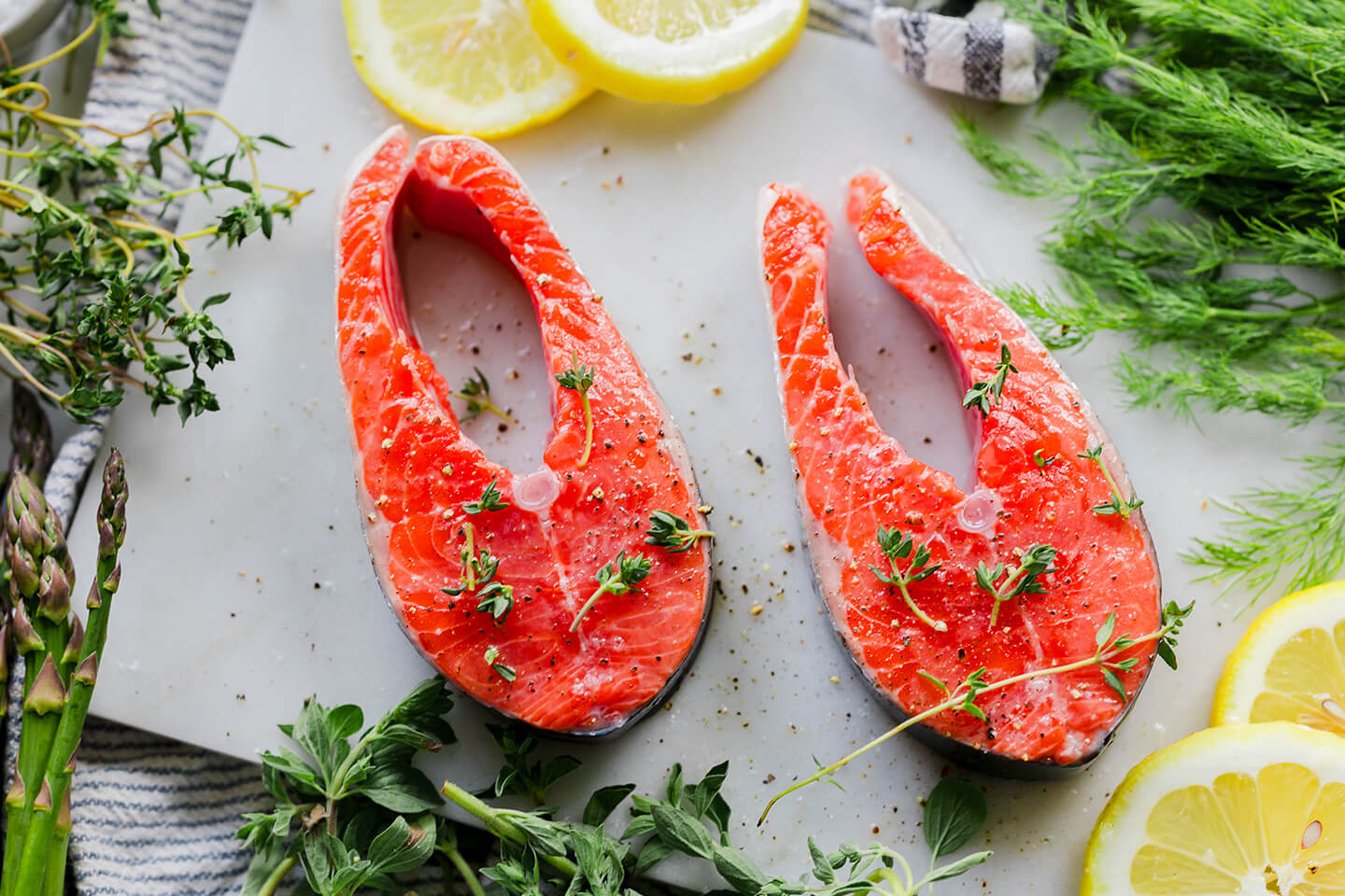 Two seasoned raw salmon steaks.