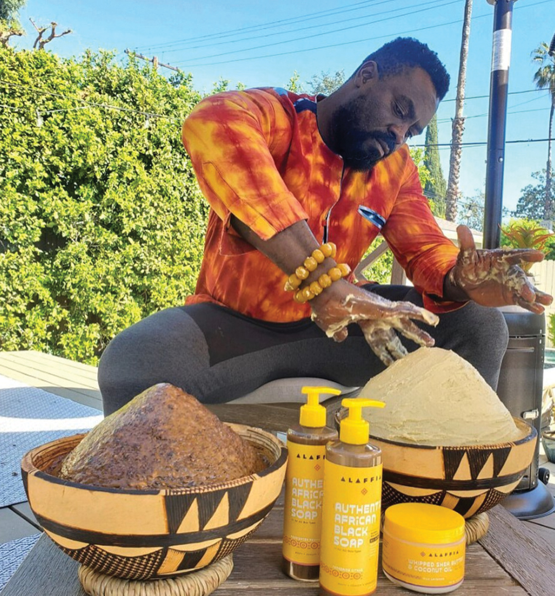 An image of entrepreneur Olowo-n’djo Tchala of Alaffia with ingredients from his natural products.