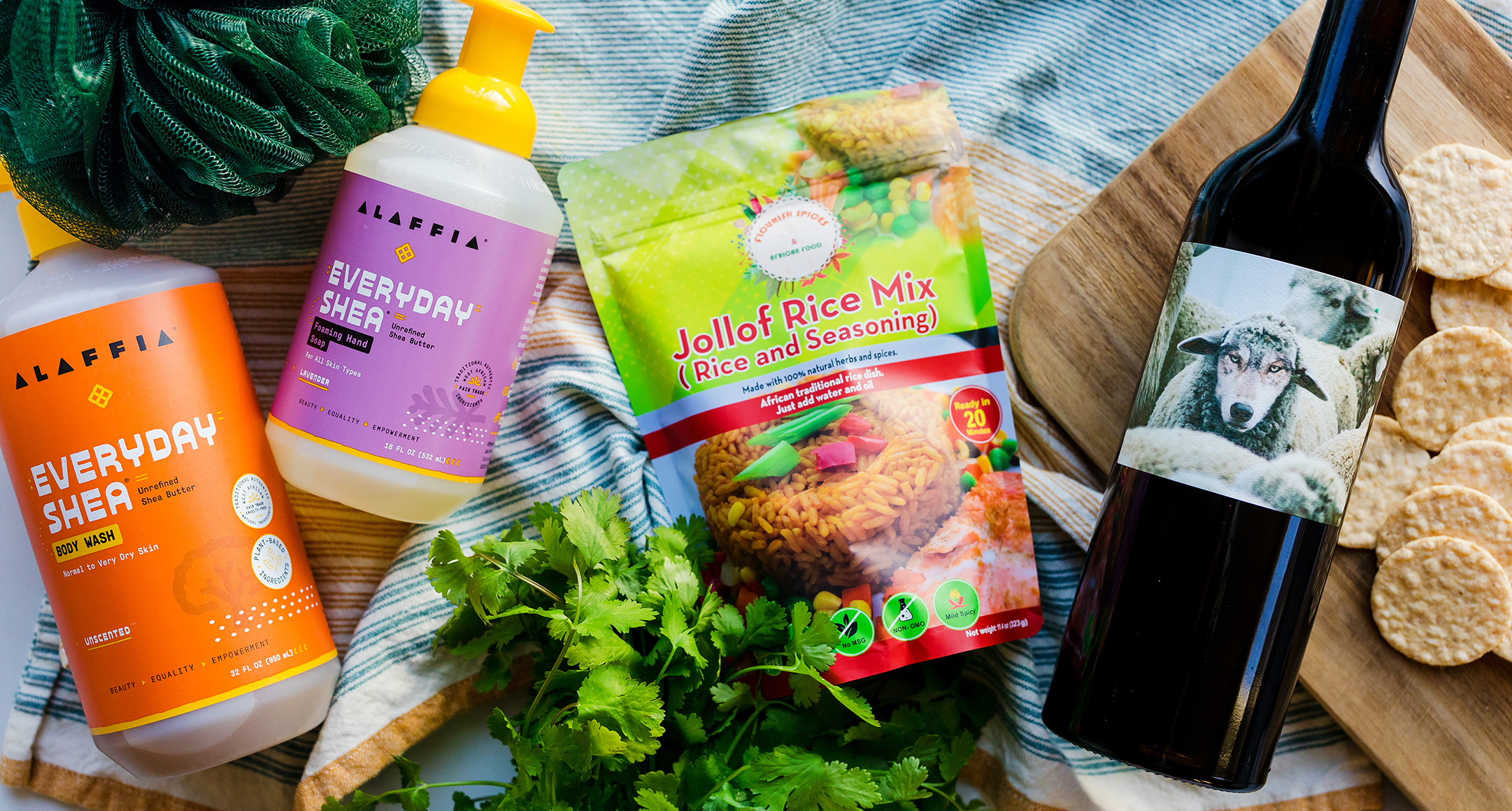 A collection of products, including body wash, jollof rice mix, and a bottle of wine. 