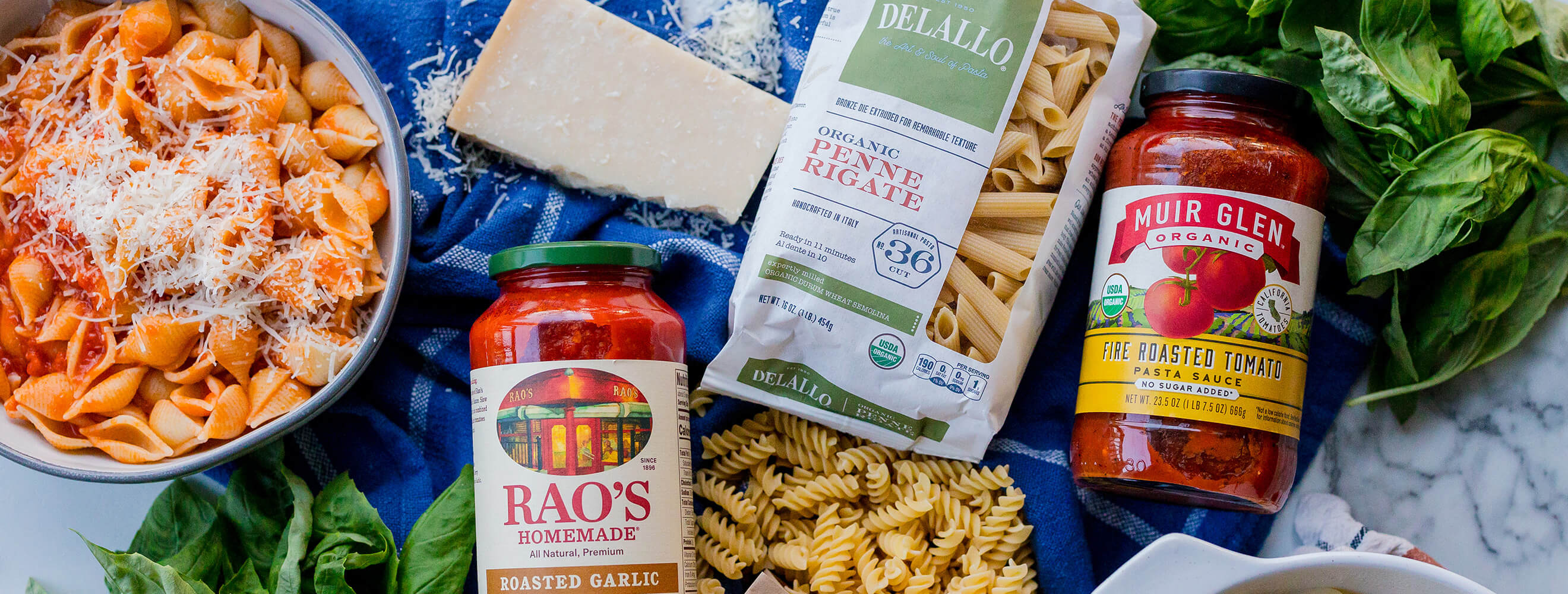 canned pasta and sauce and a bowl of freshly made pasta with red sauce and cheese