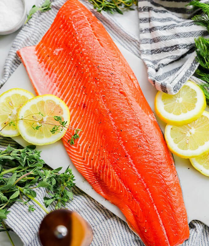 A sockeye fillet garnished with lemon slices and thyme
