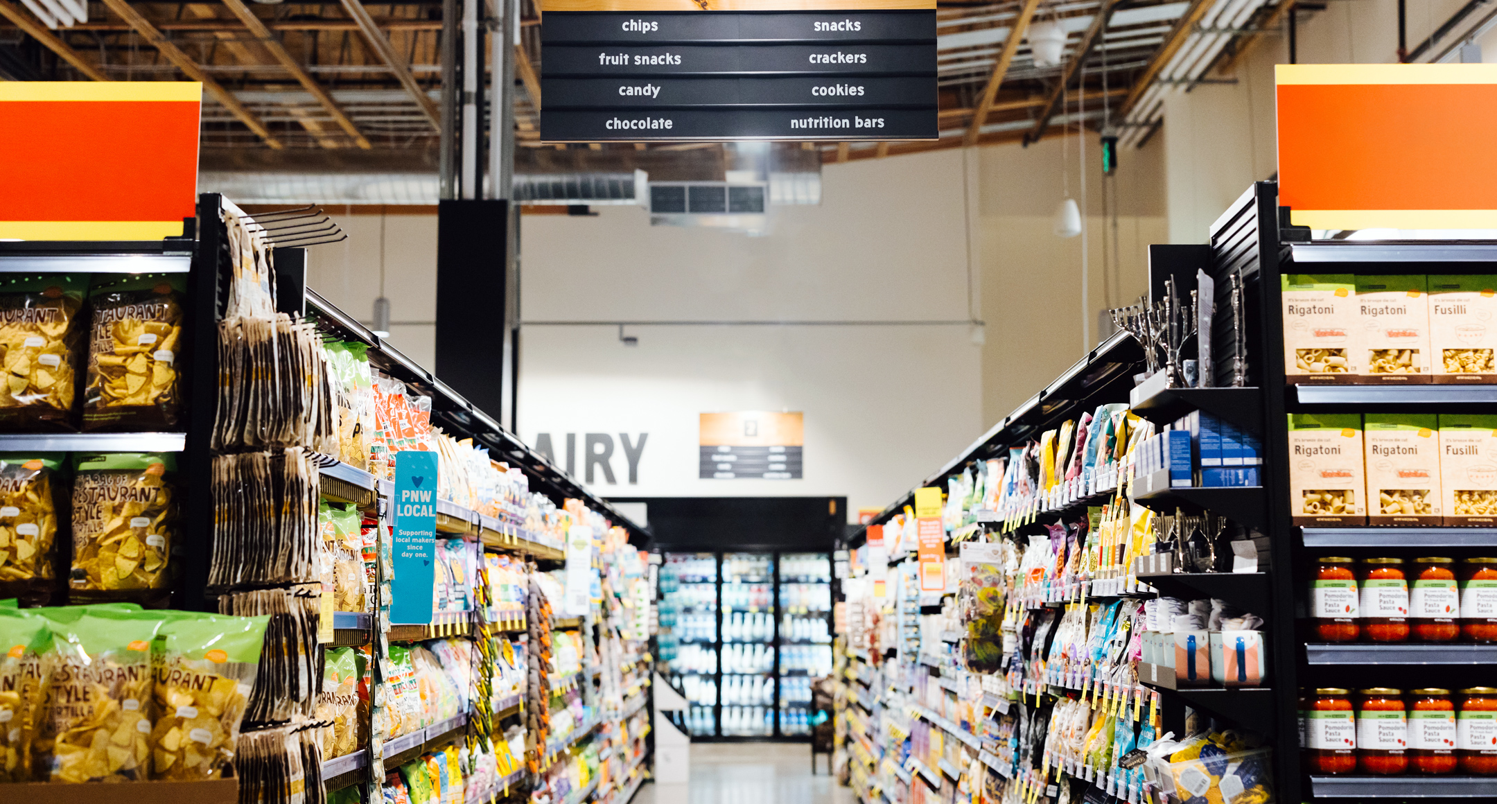 An interior photo of a New Seasons Market grocery aisle. 