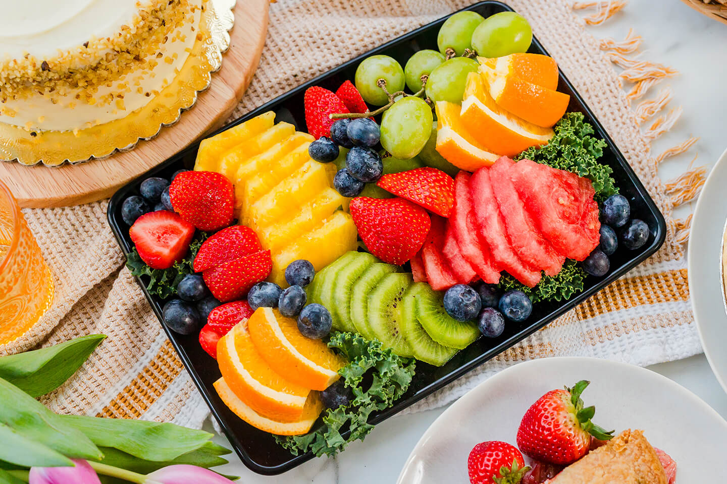 a variety of platters including fresh fruit, fresh veggies and charcuterie