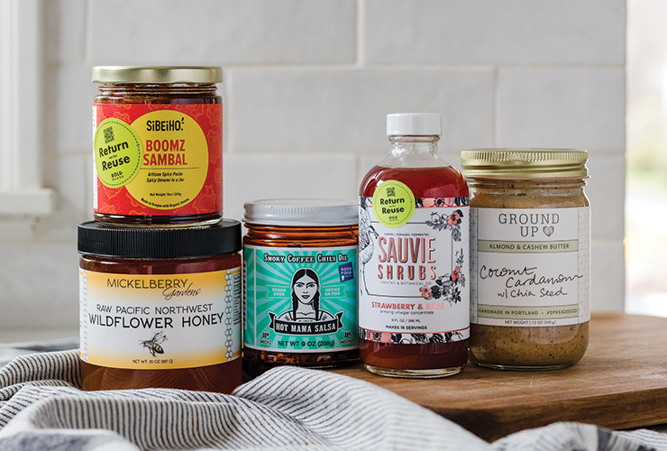 Selection of products in Bold Reuse reusable containers like Sunflower Honey and Ground Up nut butter.