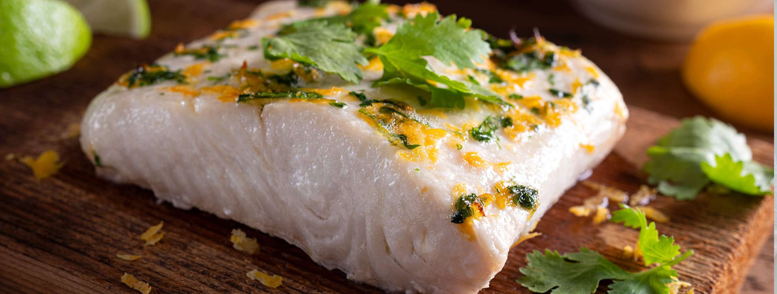 filet of halibut fish on a cutting board topped with seasonings
