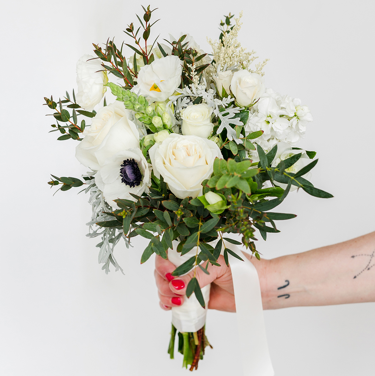 small bouquet of greenery and white flowers