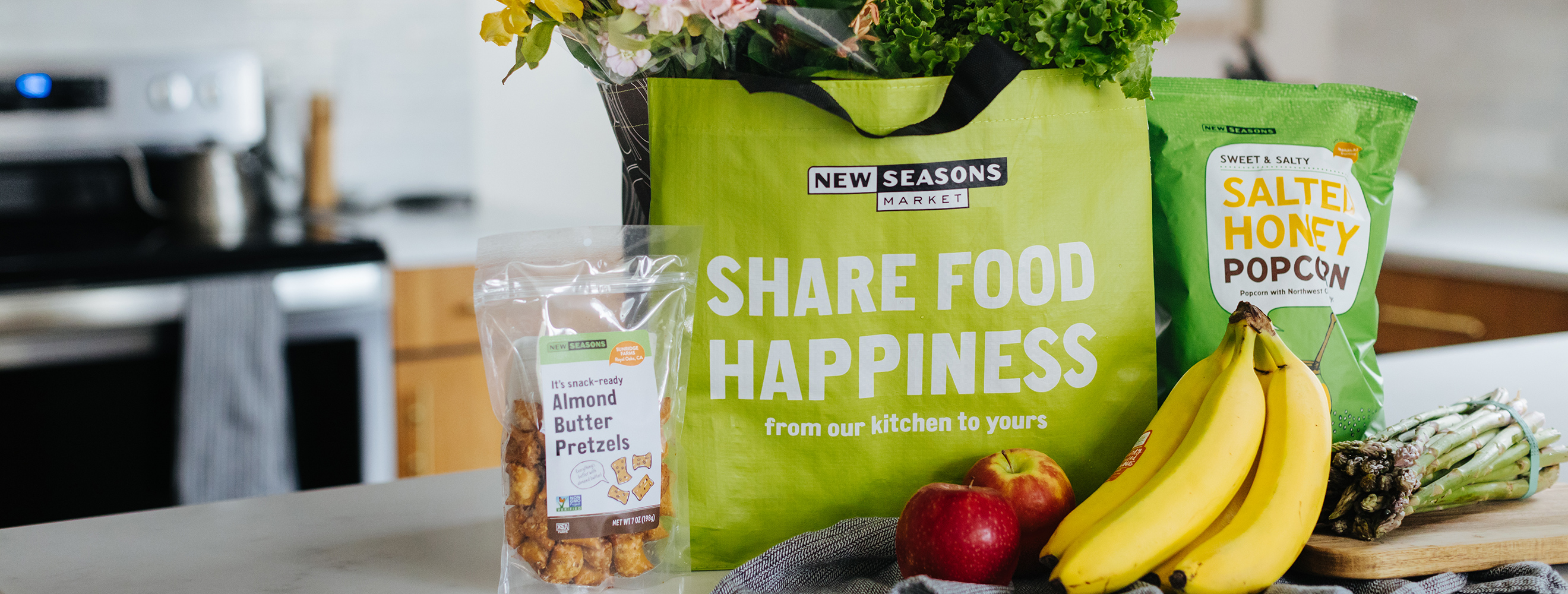 groceries in bag and on counter bag says share food happiness