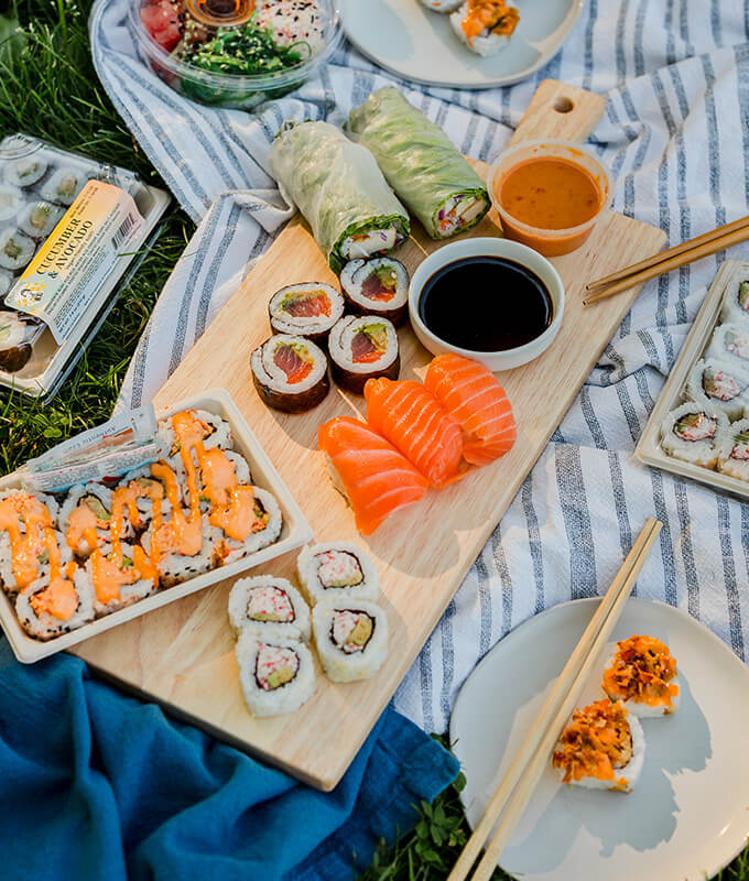 a variety of sushi in a picnic scene
