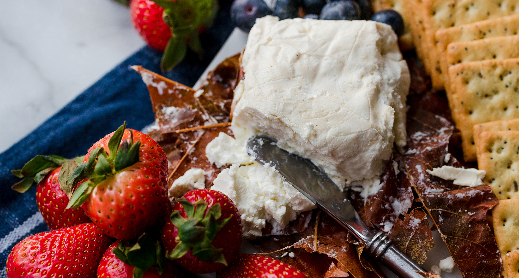 A cutting board featuring Up in Smoke Chèvre from River’s Edge Chèvre in Oregon.