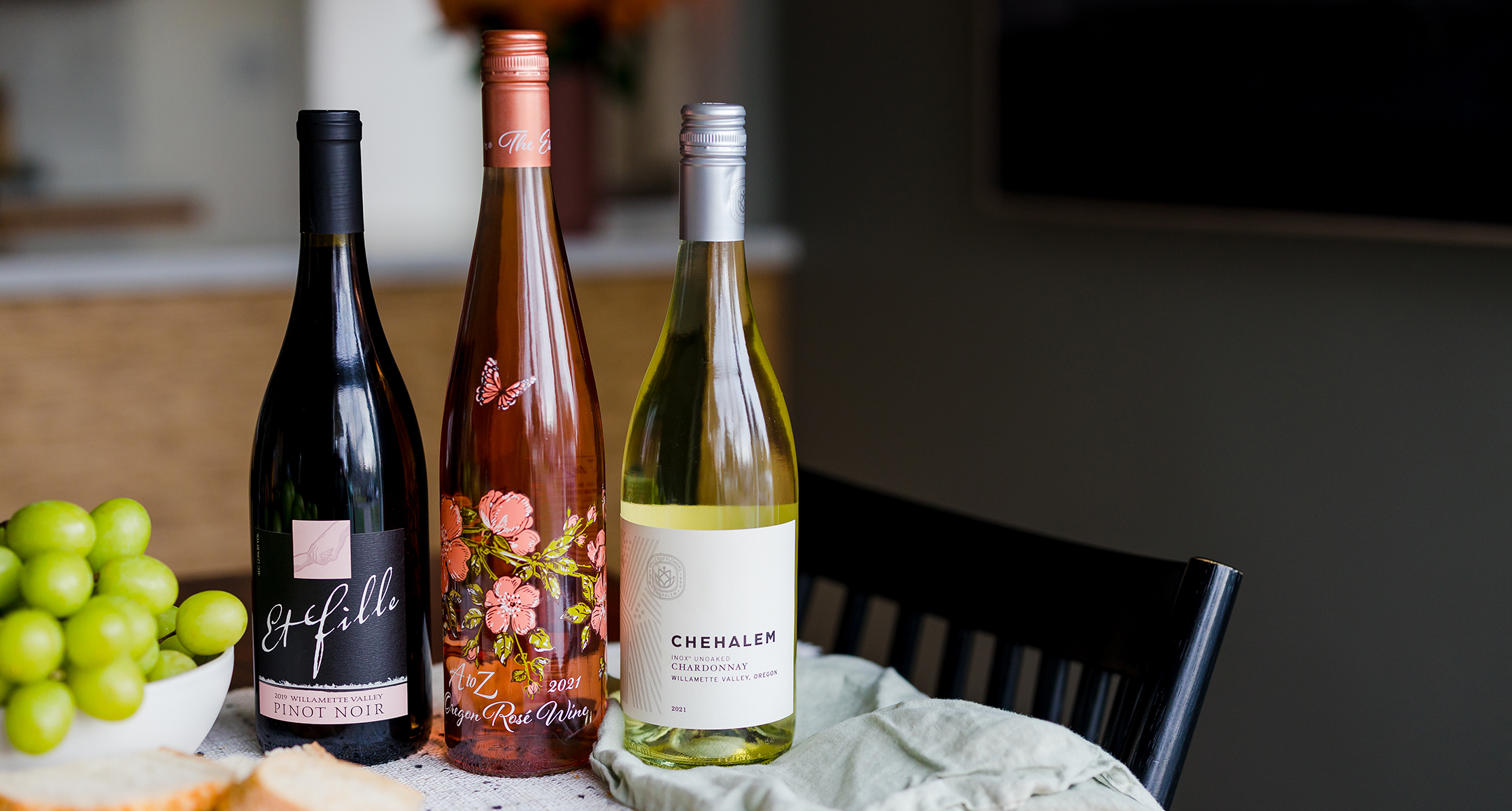 Three bottles of Oregon wine, including pinot noir, rosé, and chardonnay. 