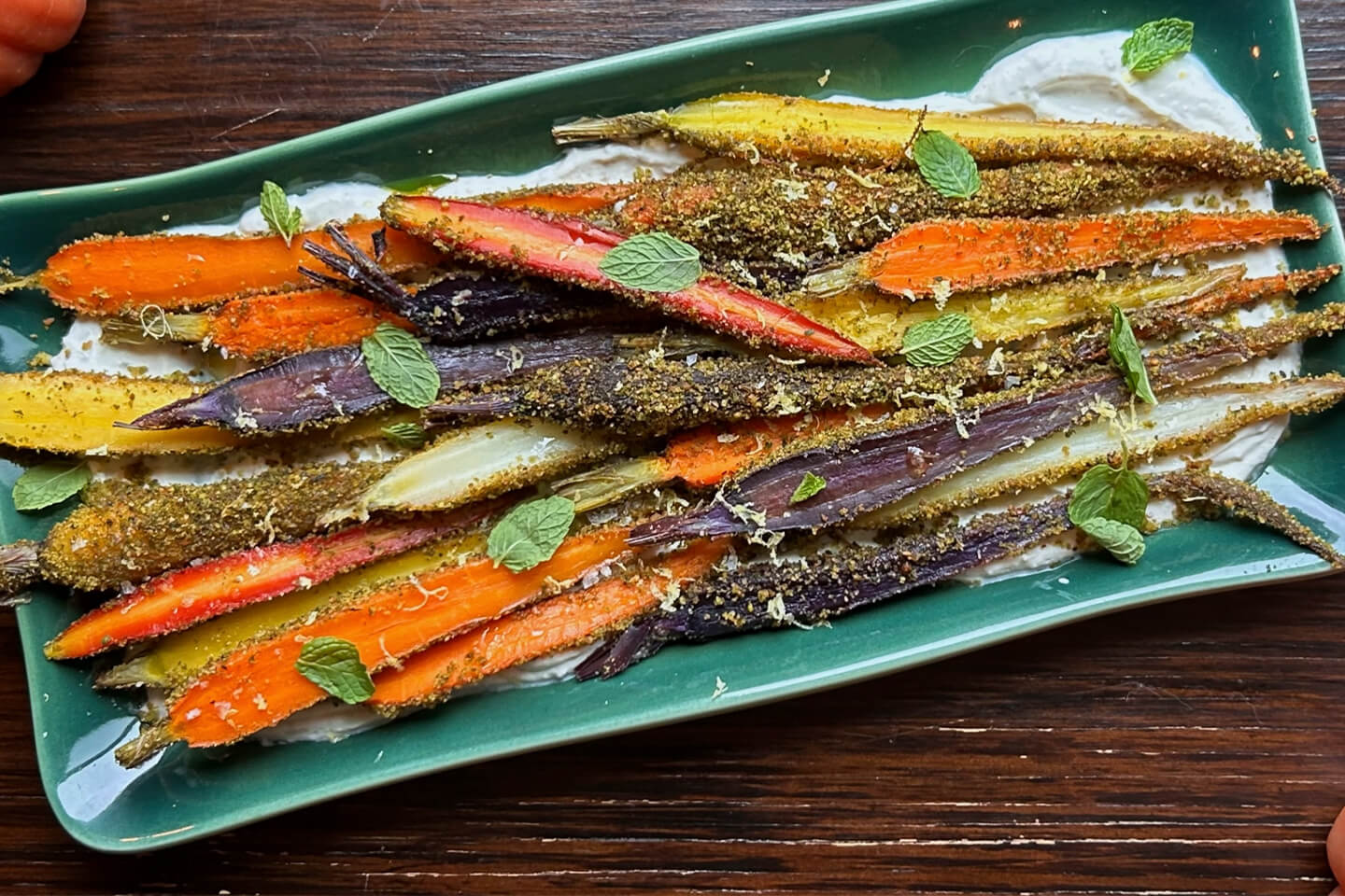 Whipped goat cheese appetizer topped with rosemary, walnuts and dried cranberries.