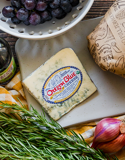 Rogue Creamery Oregon Blue cheese on a cutting board.