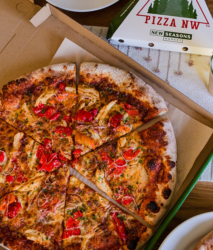 a freshly baked pizza in an open cardboard box
