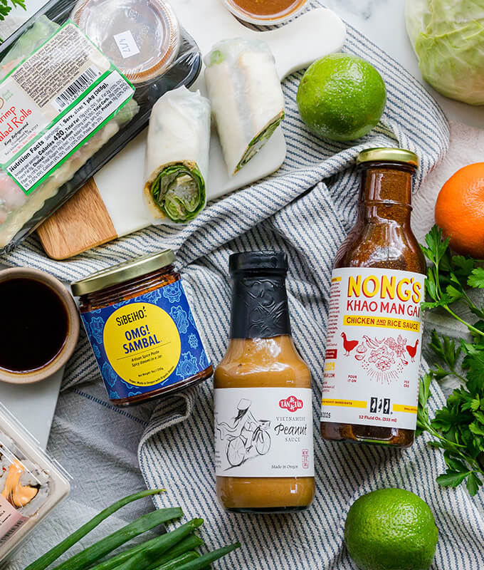 packaged grocery items like Nong's Sauce, Peanut Sauce and Chile Crisp displayed on a table.