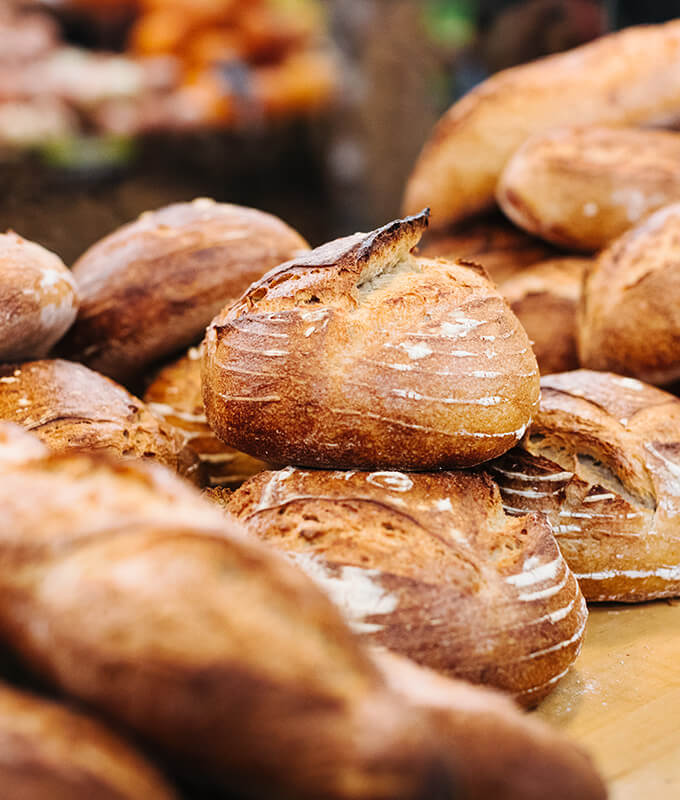 freshly baked bread displayed on a wooden counter.