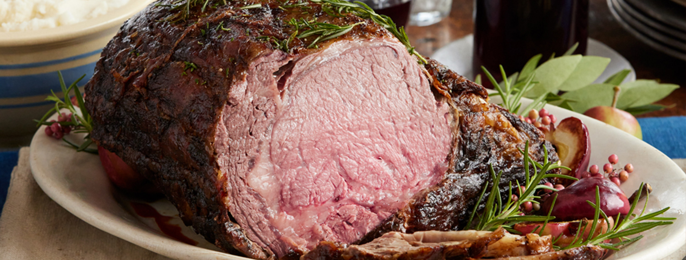 Holiday prime rib roast of beef on a serving platter.