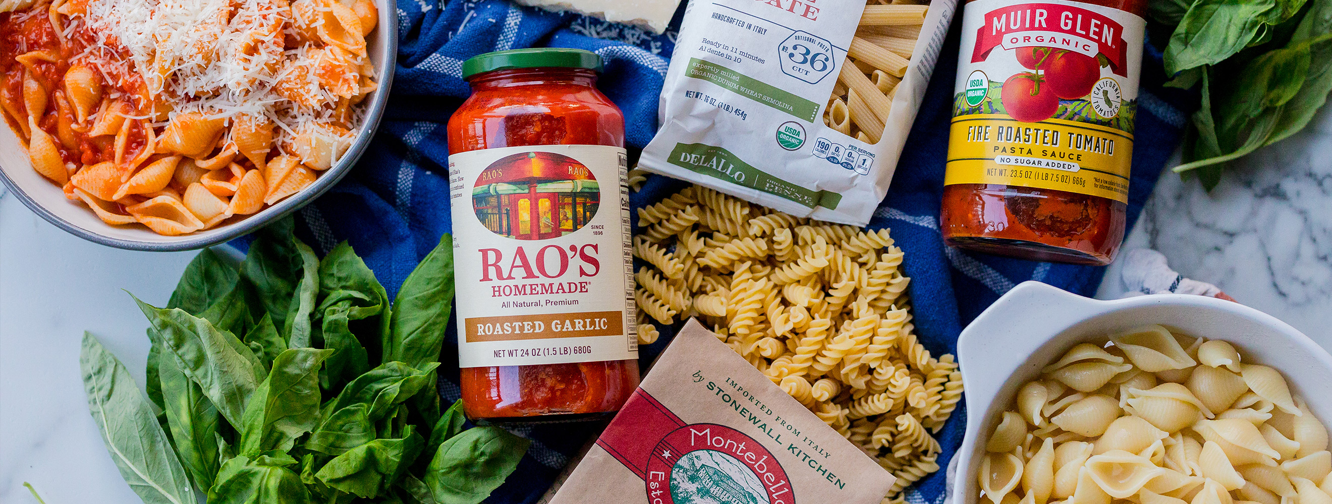 Pasta and pasta sauce laid on a table promoting a sale.